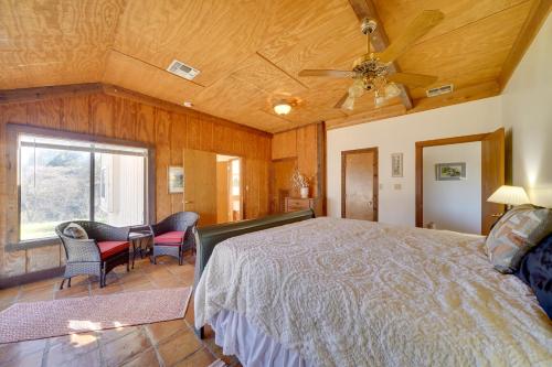 a bedroom with a bed and a table and chairs at Quiet Bandera Country Home with Medina River Access! in Bandera