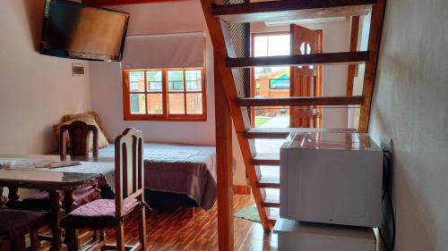 a small room with a bunk bed and a staircase at Hospedaje, Departamentos J&R in Perito Moreno
