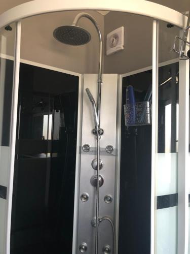a shower in a room with a shower curtain at Beauvais chambre 1 in Beauvais