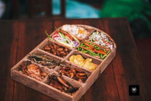 a tray of different types of food on a table at BAWANS VILLA Holiday Home for Family or Group in Hikkaduwa