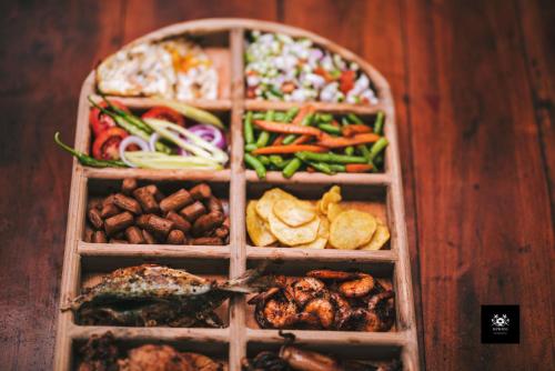 four wooden boxes filled with different types of food at BAWANS VILLA Holiday Home for Family or Group in Hikkaduwa