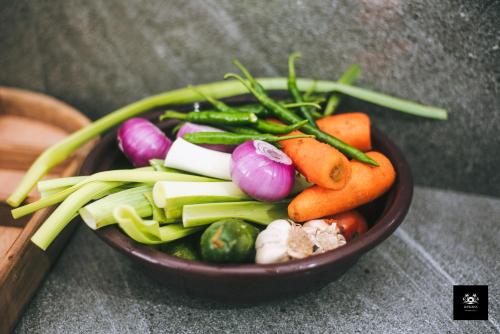 a bowl of vegetables sitting on a table at BAWANS VILLA Holiday Home for Family or Group in Hikkaduwa