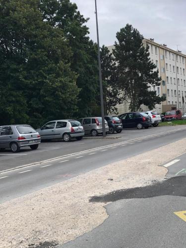 a bunch of cars parked on the side of a street at Beauvais chambre 1 in Beauvais