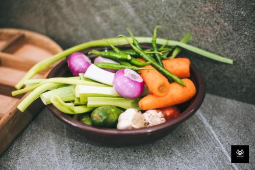 a bowl of vegetables sitting on a table at BAWANS VILLA Holiday Home for Family or Group in Hikkaduwa