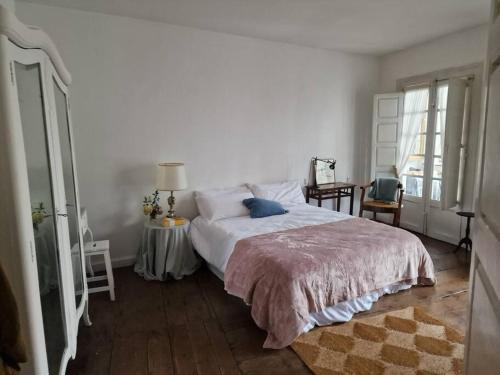 a bedroom with a large bed and a window at Mima's House · La Casa de Mima in Comillas