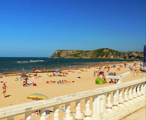 a group of people on a beach near the ocean at Mima's House · La Casa de Mima in Comillas