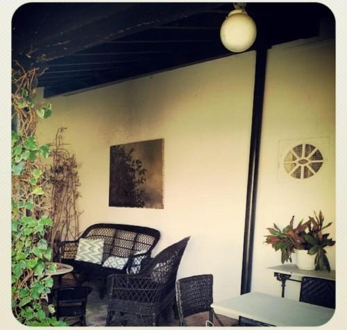 a patio with chairs and a table and a picture at Mima's House · La Casa de Mima in Comillas