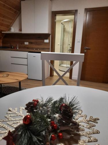 a white table with a christmas tree on it at View of the Durmitor in Žabljak