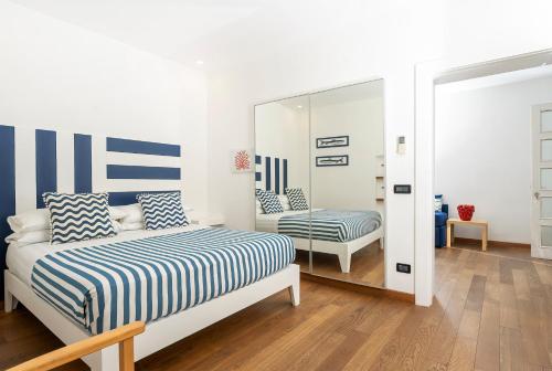 a bedroom with a bed and a mirror at Casa Zara Sorrento City Center in Sorrento