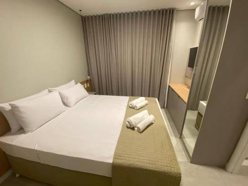 Ένα ή περισσότερα κρεβάτια σε δωμάτιο στο Edifício Sky Apt 1218-Mandi Hospitalidade