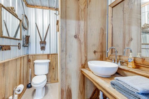 a bathroom with a white sink and a toilet at Rustic Lake City Studio Near Ichetucknee Springs! in Lake City
