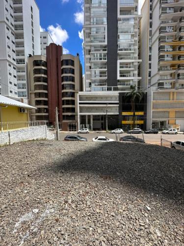 a parking lot in a city with tall buildings at Loft Lux 2 in Chapecó