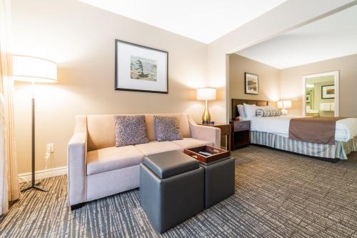 a hotel room with a couch and a bed at Horseshoe Valley Suites - The Azure in Shanty Bay