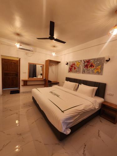 Katil atau katil-katil dalam bilik di Rihiveli Residence Thoddoo