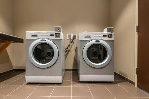 two washing machines sitting next to each other in a room at Comfort Inn St Louis Airport in Bridgeton