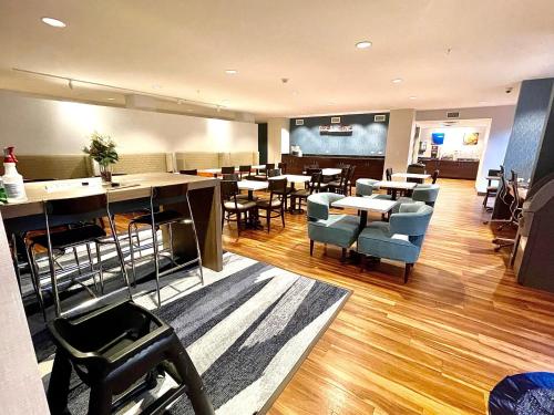 a restaurant with tables and chairs in a room at Comfort Inn St Louis Airport in Bridgeton