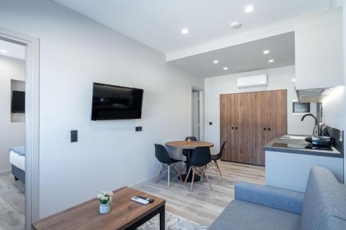 a living room and kitchen with a couch and a table at D Suites & Rooms in Ioannina