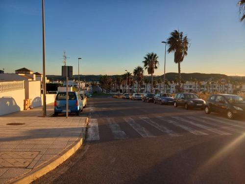 a parking lot with cars parked on the side of a street at A room with a Sun view in Orihuela