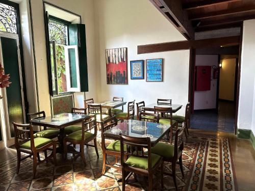 a restaurant with tables and chairs and stained glass windows at Hotel Catharina Paraguaçu in Salvador