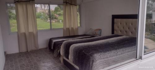 מיטה או מיטות בחדר ב-Los Talas Casa Con Pileta Tanti