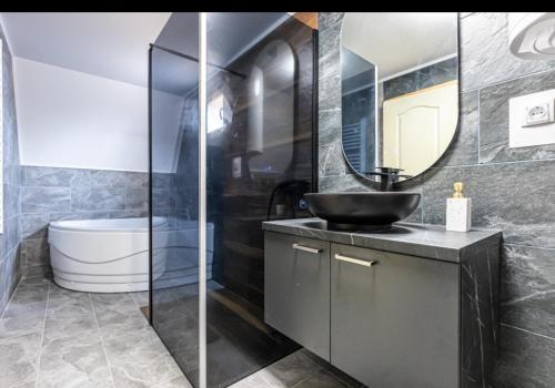 a bathroom with a sink and a mirror at Kovacevic Weekend House in Lokva
