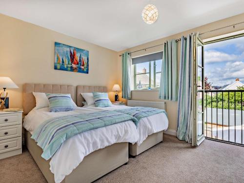a bedroom with a bed and a balcony at 3 Bed in Watchet 83532 in Watchet