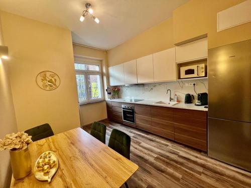 a kitchen with a wooden table and a dining room at Eva's Apartment Prague in Prague