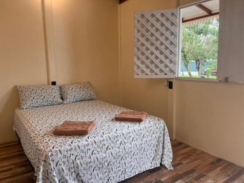 a bedroom with a bed with two towels on it at Apartamentos Sol in Cahuita