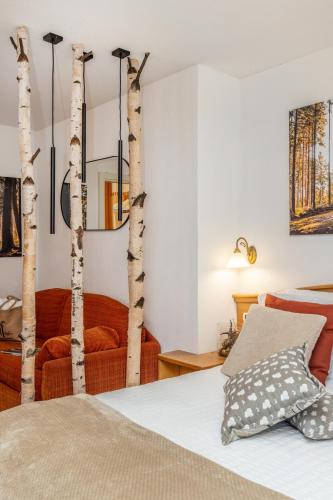 a bedroom with birch trees as the walls at Hotel Folgarida in Folgarida