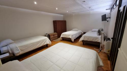 A bed or beds in a room at Hostal Magnolia