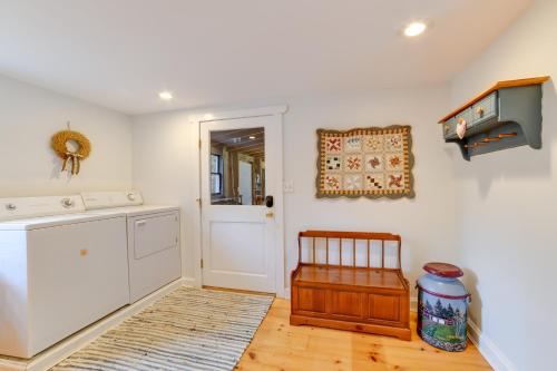 a kitchen with white cabinets and a wooden floor at Wooded Walton Home with Fire Pit and On-Site Pond! in Walton