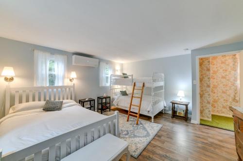 a bedroom with a white bed and a ladder at Wooded Walton Home with Fire Pit and On-Site Pond! in Walton