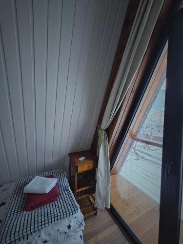 a small room with a bed and a window at B&B Cottage in Mestia in Mestia