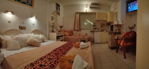 a bedroom with a large bed with a cat laying on it at evli in Rethymno