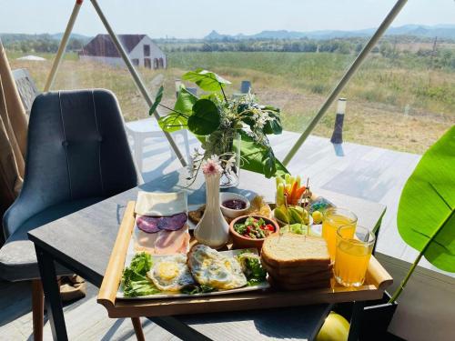 a plate of breakfast food on a table with a view at Bolnisio Resort in Bolnisi