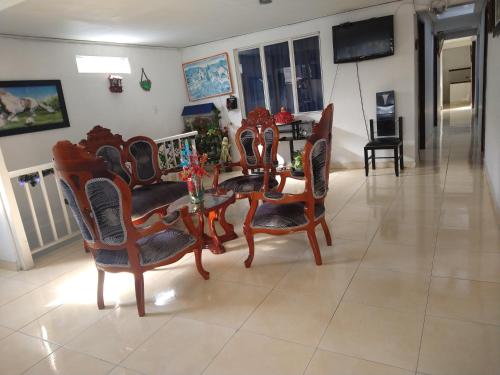 a dining room with a table and chairs at My second house in Manizales