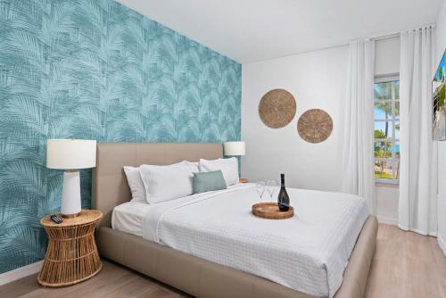 a bedroom with a large bed with a green wall at Bentley Hotel South Beach in Miami Beach
