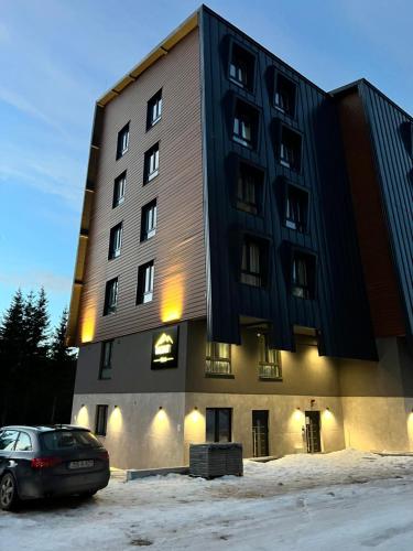 a building with a car parked in front of it at Villa Mont in Jahorina