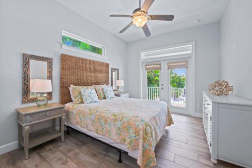 a bedroom with a bed and a ceiling fan at Spring Haven in Anna Maria