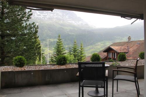 two chairs on a balcony with a view of a mountain at LODGE - Elements Lodge in Grindelwald