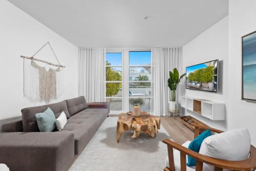 a living room with a couch and a table at Bentley Hotel South Beach in Miami Beach