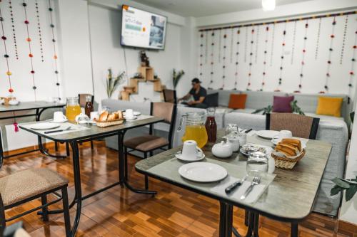 a restaurant with two tables with food on it at Escobedo’s Inn Machupicchu in Machu Picchu