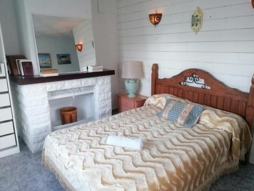 a bedroom with a large bed with a fireplace at Habitaciones Don Pancho in Sax