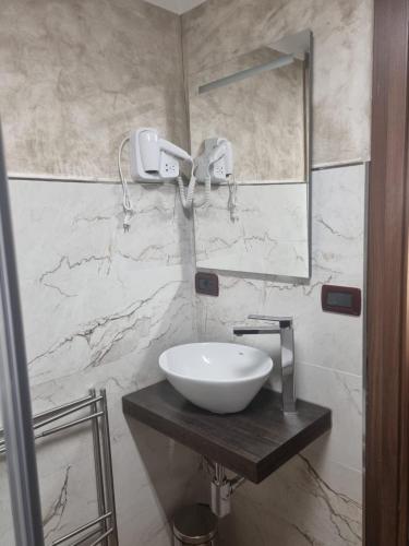 a bathroom with a sink and a mirror at Domus Aquae Rooms & Wellness SPA in Genova