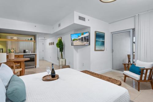 a living room with a bed and a dining room at Bentley Hotel South Beach in Miami Beach
