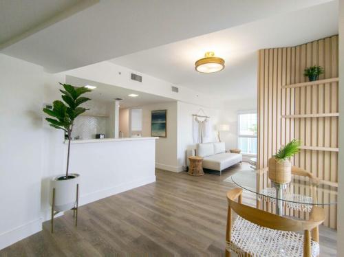 a living room with a glass table and a living room at Bentley Hotel South Beach in Miami Beach