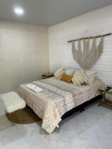 a bedroom with a large bed with a window at Deluxe Pacandé, cerca al desierto de la tatacoa in Aipe