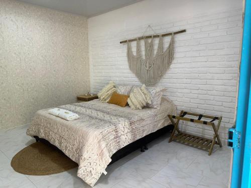 a bedroom with a bed and a chandelier at Deluxe Pacandé, cerca al desierto de la tatacoa in Aipe