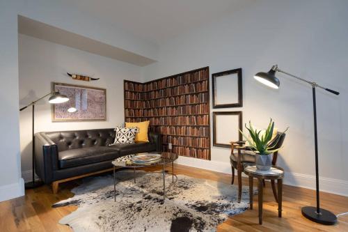 a living room with a black couch and a table at Notorious Outlaw in Denver