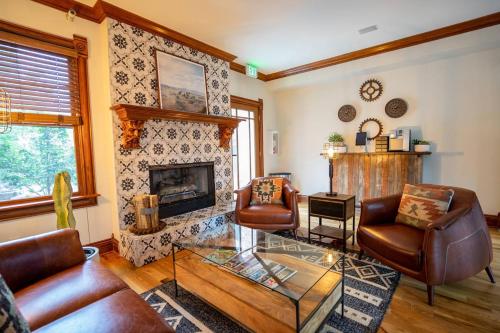 a living room with leather furniture and a fireplace at Notorious Outlaw in Denver